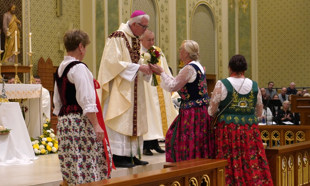 Parishioners bring flowers to Bishop Hying
